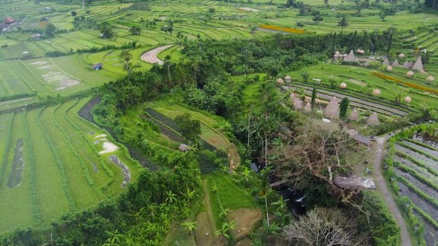 Aerial : Maha gannga valley in Bali-Indonesia, a Camp ground glamping agrotourism Inn featuring Eco Huts, mountain views to agung volcano, Rice Terraces, Palm Tree Jungles,Waterfal and photo spots.