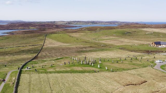 Drone shot circumnavigating the ancient Callanish Standing Stones on the Isle of Lewis, part of the Outer Hebrides of Scotland. The stones are neolithic, first erected in the Bronze Age.