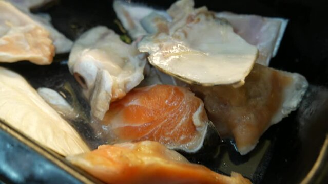 salmon head chunks ready to cook in thailand buffet restaurant