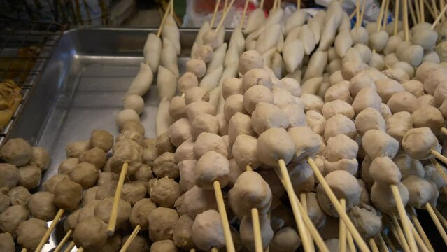 thailand night market street food booth beef pork fish meat balls in sticks ready to cook