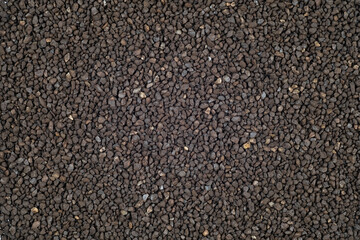 Ion-exchange Manganese green sand for water softening beads or granules texture background....