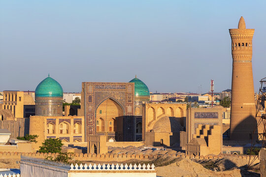 Panoramic view of Bukhara historical center. Kalyan Minaret and Poi Kalyan architectural complex at sunset light. Tourism, history or architecture concept. Bukhara, Uzbekistan