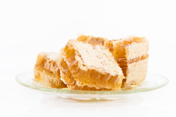 honeycomb piece with honey close-up on white background