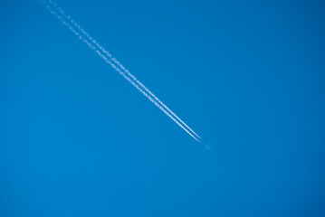 shot of a jet plane high in the blue skies