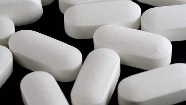 Close up white medical pills and drugs, antibiotic, steroid and antispasmodic. Medicine background. Pharmaceutical industry.