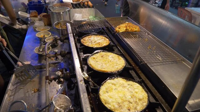 pan fried oyster pan cake omelette in thailand night market street food restaurant