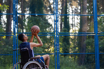 Wheelchair basketball payer dribbling ball like professional, ready to shoot and score goal.