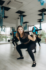 Group of women with barbells in gym. Multiracial group of females exercising together in fitness class.