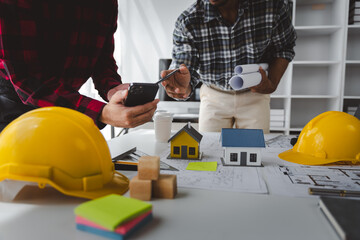 Engineers work as a team with blueprints for architectural plans. Engineer sketching construction project concept with architect equipment Architects talking at table Teamwork and construction concept