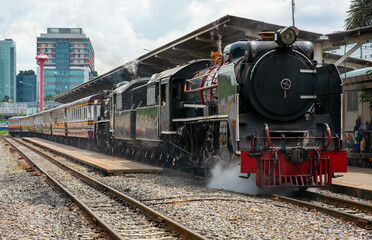 Fototapeta na wymiar Special Train Pacific Type Steam Locomotive Traveling Passengers in Thailand