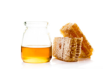 Bee products with honey and sweet honeycomb isolated on white background