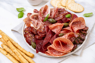 Charcuterie plate Italian prosciutto ham, parma ham, salami, bresaola beef olives and  breadstick. ...
