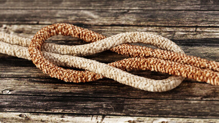 Tied ropes standing on wooden background. 3D illustration