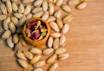 Various oriental sweets with pistachios on a brown background