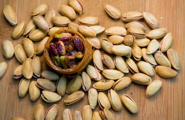 Various oriental sweets with pistachios on a brown background