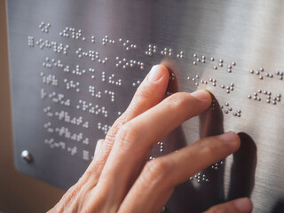 Braille Alphabet with People hand Blind Reading 