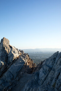 Rocky precipice foreground overlooking city vertical