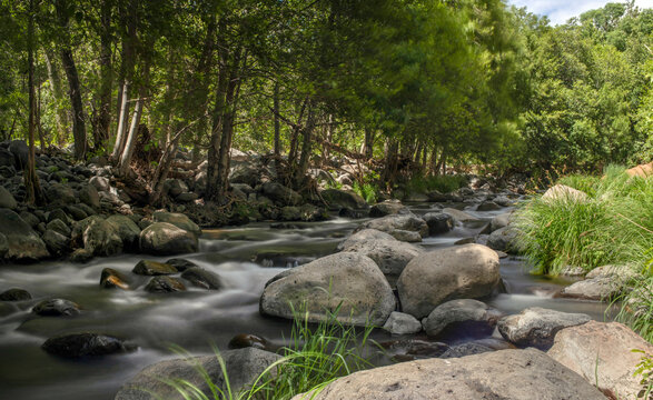 Water blurred from movement flowing over rocky stream bed