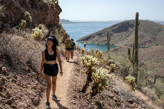 Hikers on mountain trail with lake in background