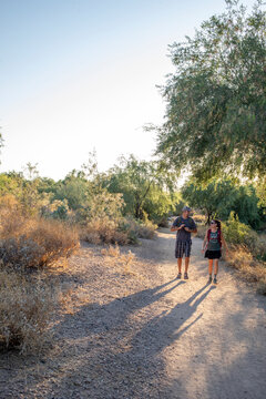 Couple hiking desert nature trail vertical
