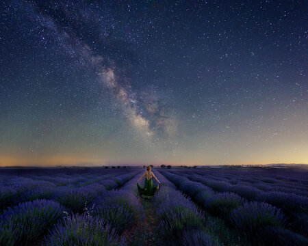 woman at dusk in a lavender field witch sky with milky way
