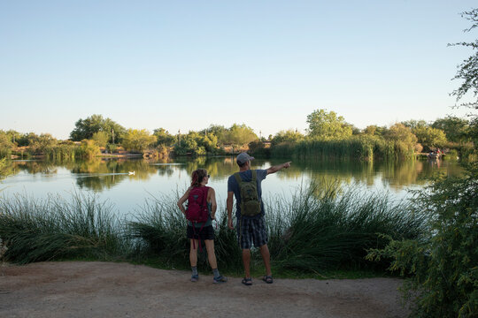 Couple looking out at lake from nature trail