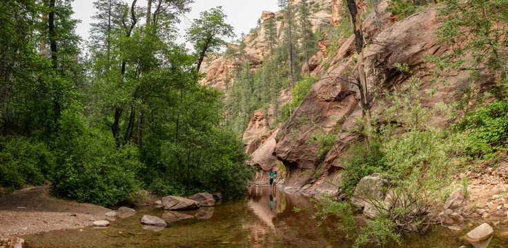 Young couple wading in rocky stream
