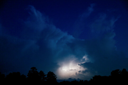 Lightning bolt in sky during an evening Texas thunderstorm.