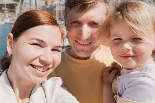 Selfie portrait of a happy family with a small child on vacation