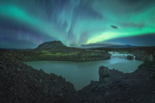 Auroras over Þjófafoss, an incredible waterfall in Iceland