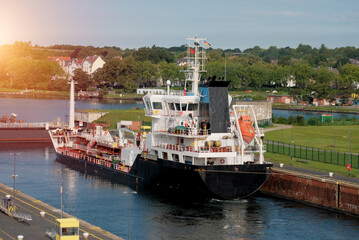 Handy-size oil tanker moored in the shipping lock. Kiel canal transit. Shipping channel for transit...