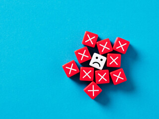 Rejection, disapproval and stress. Making too many mistakes. Unhappy face surrounded with cubes...