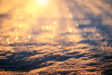 Snow with bokeh from hoarfrost at gold sunrise. Merry christmas background.