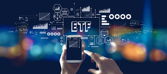 ETF theme with person using a smartphone in a city at night