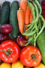 Wooden crate full of healthy colorful seasonal fruit and vegetable. Top view.