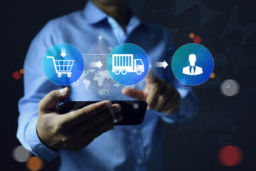 Businessman hand holding smartphone and tracking parcel package shipment or travel status from...