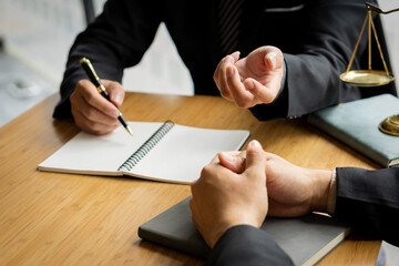 Businessman and lawyer discussing contract documents sitting at table Legal concepts, advice,...