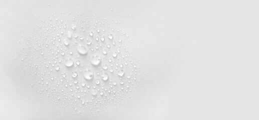 water drops of transparent gel serum on gray background
