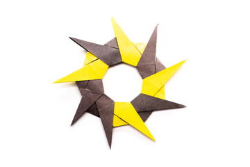 Paper 9 point ninja star on a white background. origami modular star