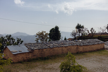 Fototapeta na wymiar Detailed view: Traditional stone hut made of rocks and mud, Uttarakhand, India. Countryside craftsmanship