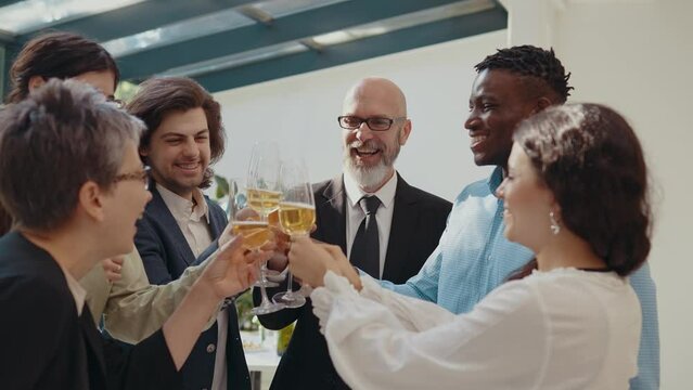 Cinematic footage of a business corporate party. Group of businessmen and businesswomen celebrating the annual company achievements