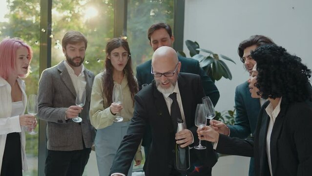 Cinematic footage of a business corporate party. Group of businessmen and businesswomen celebrating the annual company achievements
