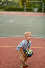 A little boy is playing with a ball