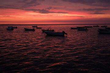 Fototapeta na wymiar Fishing boats in the red Sunset light