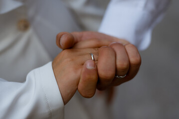 hands of groom and bride