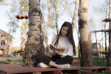 Portrait of a beautiful girl with a book.