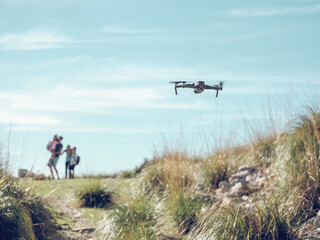 Fototapeta na wymiar Drone flying over grass in nature