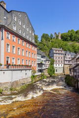 Fototapeta na wymiar Half-timbered houses on the banks of the Rur in Monschau with the Haller ruins in the background