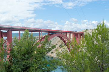 Fototapeta na wymiar Red bridge Maslenica in Croatia, deck arch bridge over the Adriatic sea
