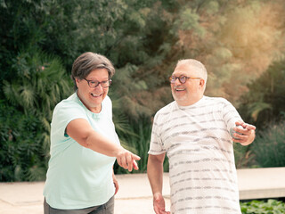 man and woman laughing at a game of boules